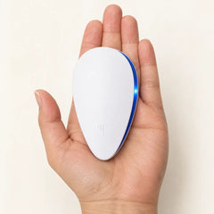 Compact ultrasonic pest repeller held in a hand showing its palm-sized design